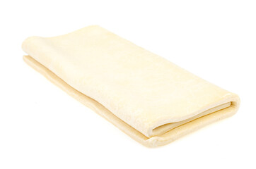 Folded plate raw dough on white background.
