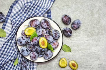 Ripe blue plums on a plate