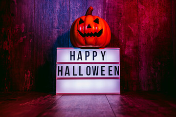 Light box with 'Happy Halloween' message and small pumpkins with blue and red atmosphere