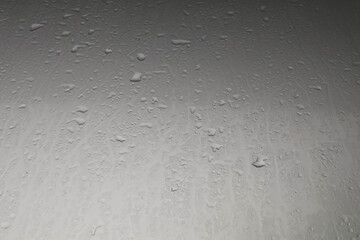 Water droplets on the hood after rain on a stormy day reflected in the gloomy sun all day on warm cold evenings. Quiet and lonely, scary