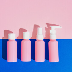 natural cosmetic cream , serum, skincare blank bottles. bio organic products on pink and blue background. minimal beauty and spa concept. flat lay