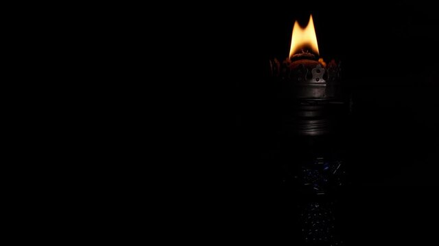 A kerosene lamp burns in the dark