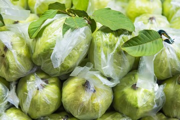Fresh guava fruit. Green background.