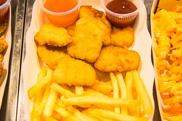 Selective focus of Fast food in a paper box with a serving.