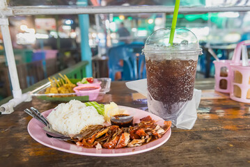 Food and drinks on wooden tables in floating markets in Thailand