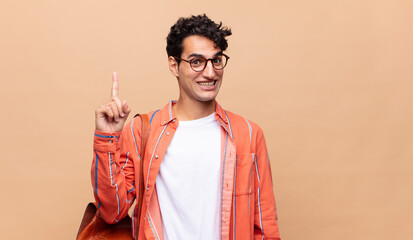 young student feeling like a happy and excited genius after realizing an idea, cheerfully raising...