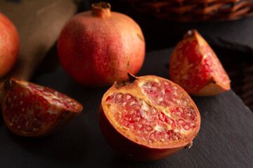 pomegranate fruit, placed on a black slate