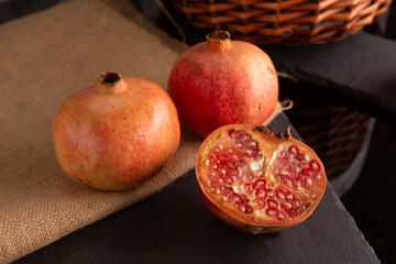 pomegranate fruit, placed on a black slate
