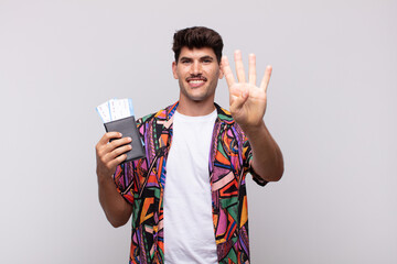 young tourist with a passport smiling and looking friendly, showing number four or fourth with hand...