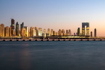 View of A Jumeirah Beach Residence and Blue watersafter sunset. Shot made from Palm Jumeirah, man made island. Dubai, UAE.