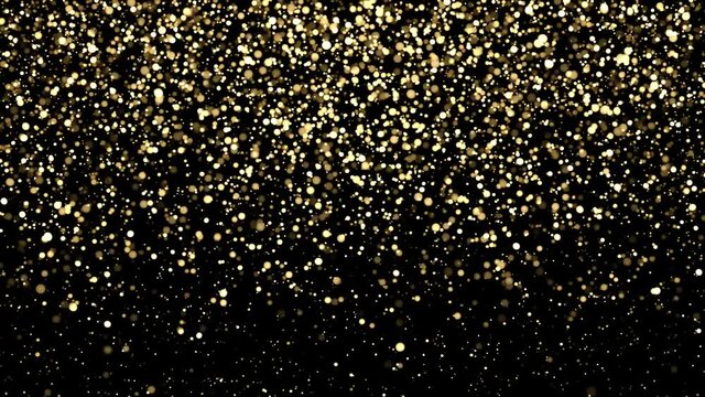 Bokeh of glittering particles falling on black background