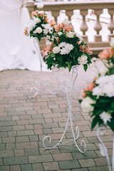 Wedding floral decor in warm pastel colors for the wedding ceremony. Floral details.