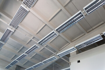 Industrial mercury lamps in rectangular lamps in an old building.