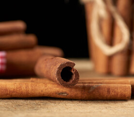 dry brown cinnamon sticks on wooden background