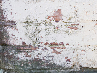 Old brick wall with white paint background texture close-up.