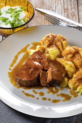 Braised pork neck in own sauce served with boiled potatoes.