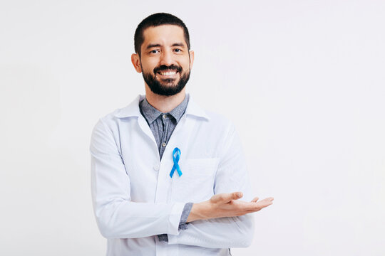 Prostate Cancer Awareness. Doctor man holding light Blue Ribbon for supporting people living and illness. Men Healthcare and World cancer day concept