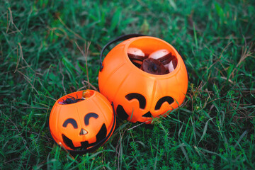 halloween candy baskets lie on the grass