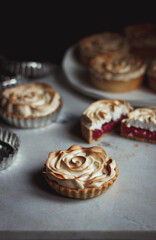 flower tart with raspberry red filling and meringue