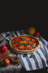 pie with colorful tomatoes and basil