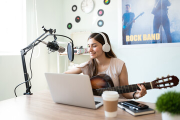 Cute musician recording a song in her studio