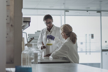 Two female scientists discussing results of experiment