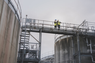 Industrial workers using a digital tablet on site