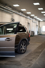 Car in a modern garage being worked on (shallow DOF/color toned image)