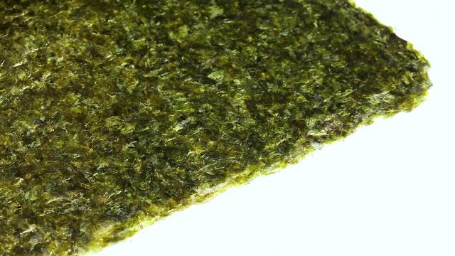 Turning pages of thin sheets green nori