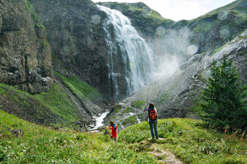 Hikers watching at the Engstligenfälle, the second highest falls (600 m) in Switzerland