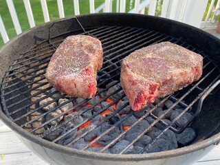 Seasoned Rib Eye Steaks on a Barbecue Grill
