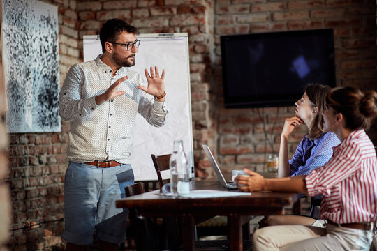 A young couple discussing an unpleasant situation with a waitress