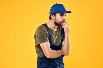 man in work uniform rendering service forklift work lifestyle yellow background