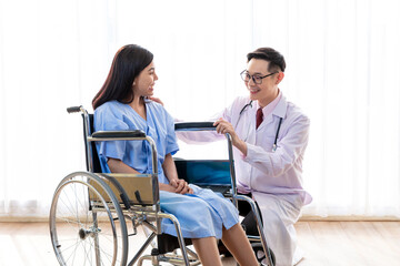 Fototapeta premium Doctor talking to woman in wheelchair after surgery. Doctor consulting, encourage patient about treatment before discharging from hospital. Medicine, Age, Health Care and People concept, Covid19.