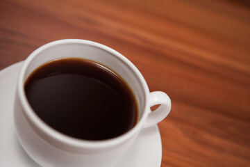 Coffee cup top view on wooden table background