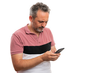 Adult man looking at phone screen as typing text message