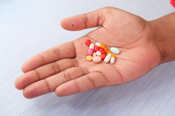 Close up of man hand taking medicine 