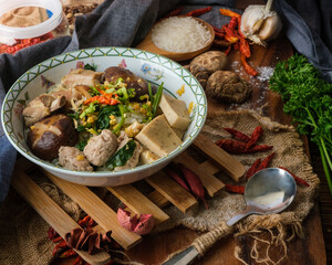 Boiled rice with pork, porn bone and thai pork sausage in bowl. Thailand is a popular breakfast.