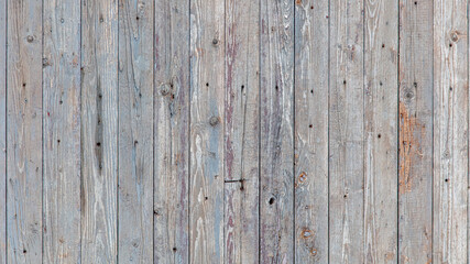 Fototapeta na wymiar Wooden boards on an old fence as an abstract background.