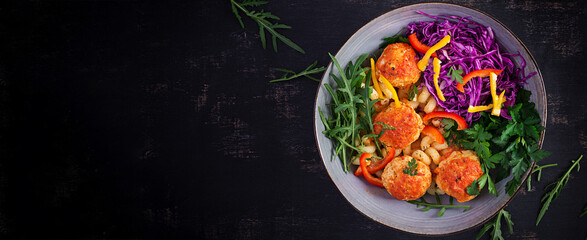 Italian pasta. Cavatappi with meatballs and salad on dark background. Dinner. Top view, banner. Slow food concept