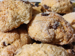 Homemade cottage cheese cookies with raisins sprinkled with sugar close-up.