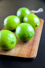 Organic fresh limes on a cutting board