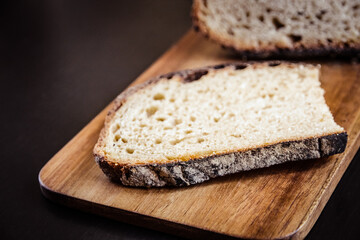 Traditional French country bread slices on a cutting board