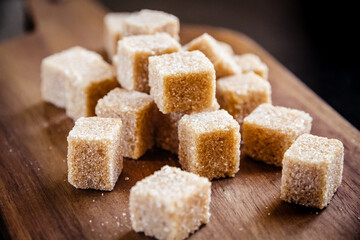 Brown cane sugar cubes on a cutting board