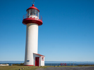 Stunning old lighthouse with a blue sky as a background