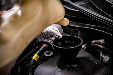 Fototapeta na wymiar Close-up of oil change in a car during service.
