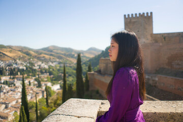 Fototapeta premium lifestyle portrait of young beautiful and happy Asian Korean tourist woman having Summer holidays in Europe enjoying cheerful visiting beautiful Alhambra of Granada in Spain