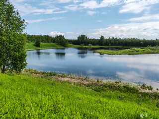 a small river in it clouds are reflected