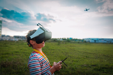 boy flying drone in virtual reality glasses outside