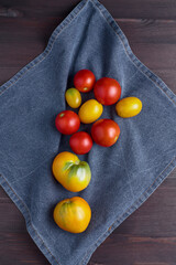 beautiful ripe tomatoes on a blue kitchen towel. organic vegetables, autumn harvest, top view